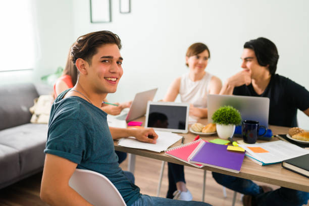 Handsome latin man happy to be in a study group stock photo