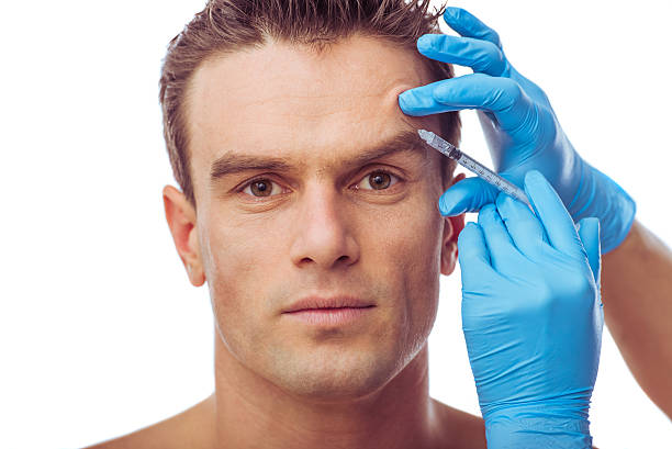 Handsome man and plastic surgery stock photo