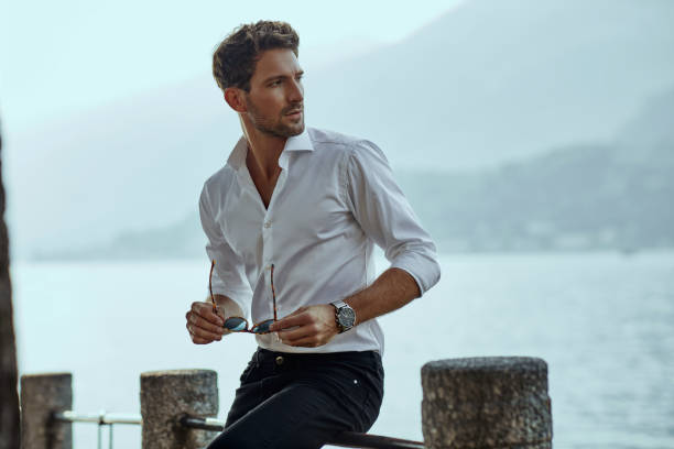 Handsome man in casual clothing Stylish man in white classic shirt, looking at the mountains view handsome people stock pictures, royalty-free photos & images