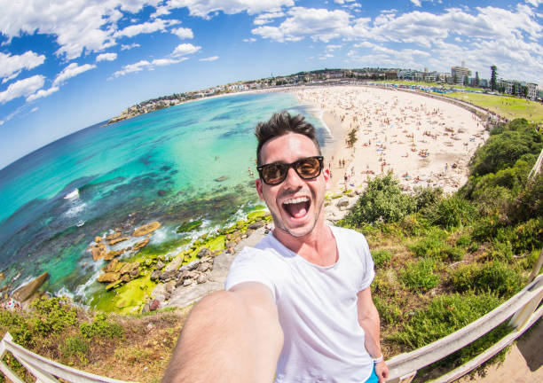 Handsome man taking a selfie on vacation stock photo