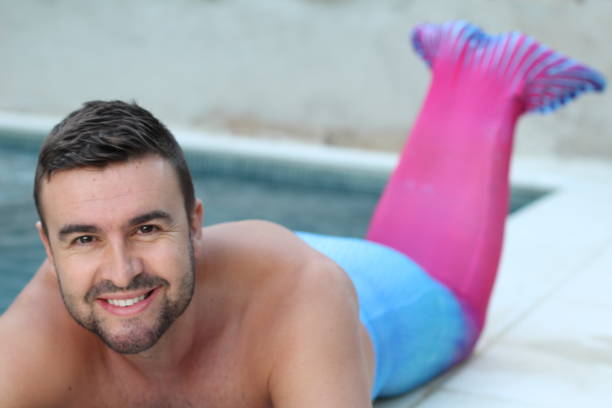Handsome merman in swimming pool Handsome merman in swimming pool. merman stock pictures, royalty-free photos & images