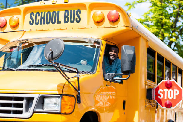 handsome senior school bus driver looking at camera through window  school bus driver stock pictures, royalty-free photos & images