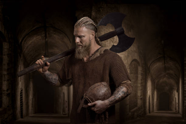 A handsome viking warrior in a fantasy outdoor fairytale setting stock photo
