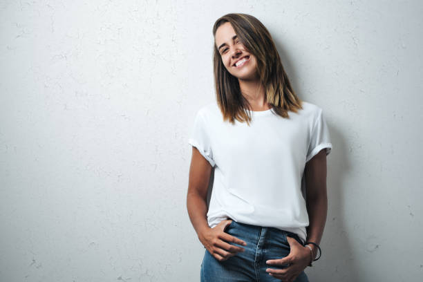 Handsome woman in white blank t-shirt, studio model stock photo