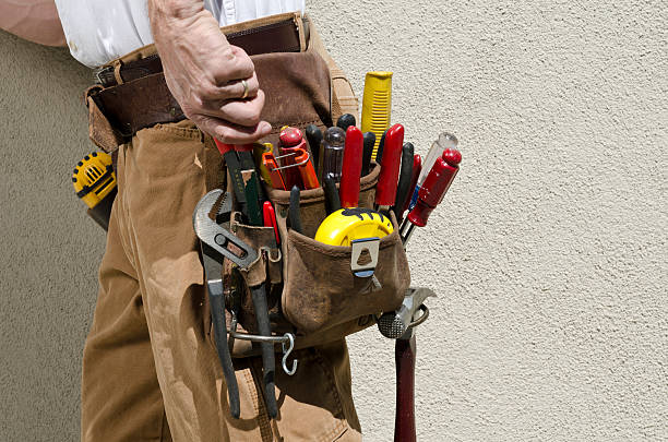 Handyman With Tool Belt Male handyman with tool belt against stucco wall. tool belt stock pictures, royalty-free photos & images