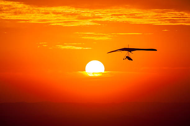 Hang gliding in the sunset stock photo