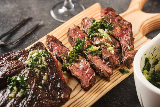 Hanger steak bbq with souce chimichurri, close up stock photo
