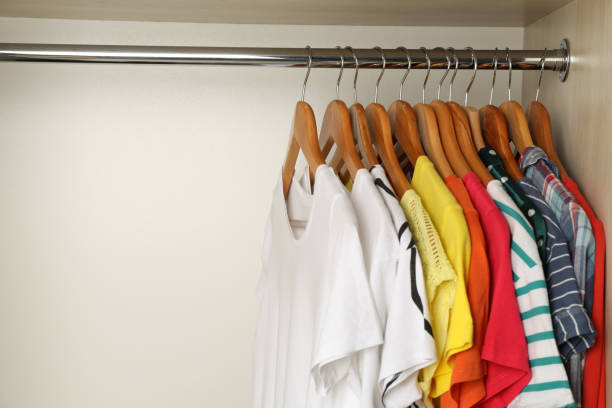 Hangers met heldere kleren op rek in garderobe, ruimte voor tekst​​​ foto