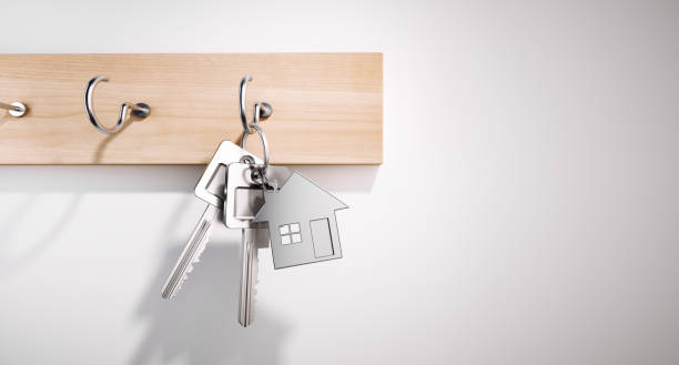 Hanging House Keys with Keyring House Keys with Key Ring hanging on wooden Board first time home buyer stock pictures, royalty-free photos & images