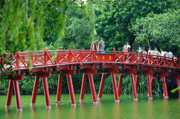 Hanoi red bridge. The wooden red painted bridge over the Hoan Kiem Lake connects the shore and the Jade Island on which Ngoc Son Temple stands stock photo