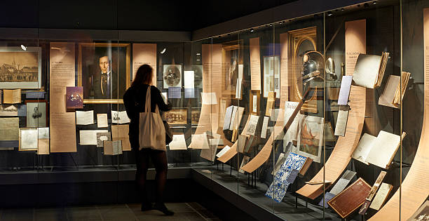 Hans Christian Andersen Museum Odense, Denmark - May 2, 2014: The museum for the world famous Danish fairy tale writer Hans Christian Andersen. From the collection about the author in the museum a tourist is studying the poet's belongings. Museum stock pictures, royalty-free photos & images