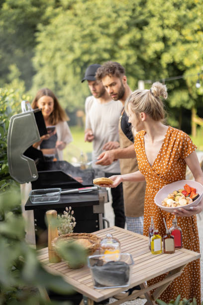 Happe friends cooking on a grill at backyard stock photo