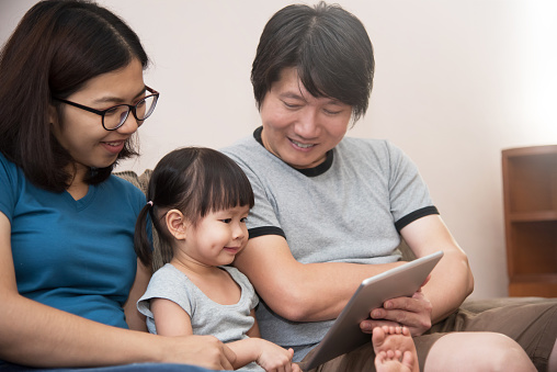 Happiness Of Asian Family Sitting And Playing Digital Tablet Stock Photo -  Download Image Now - iStock