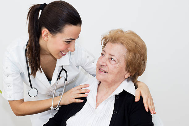 Happiness senior woman with young nurse stock photo