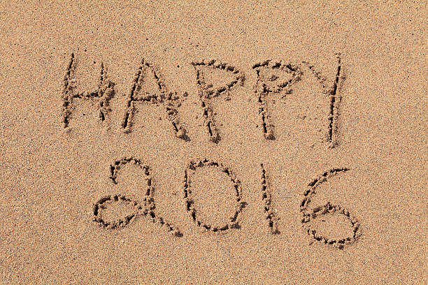 "Happy 2016" written in sand stock photo