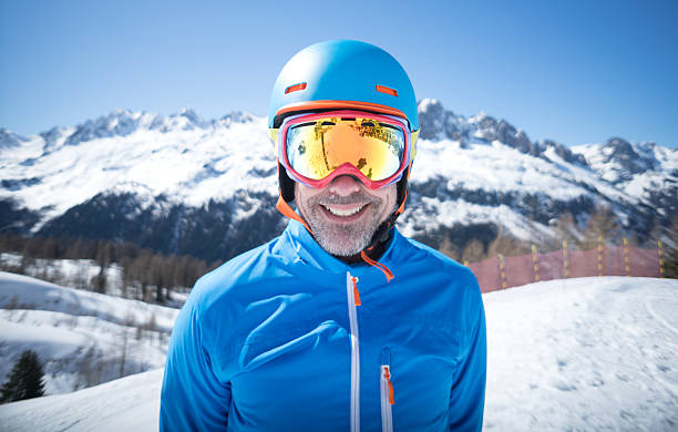 happy adult man skiing - posing with ski stockfoto's en -beelden