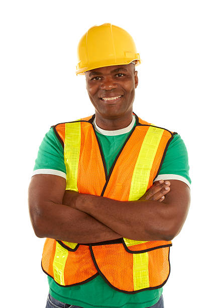 happy african american construction with arms crossed stock photo