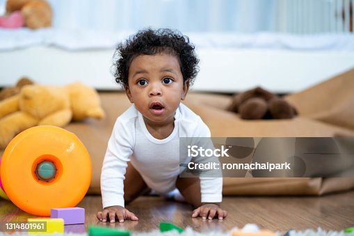 istock Happy African American Little baby boy crawling and looking for some thing to learn 1314801961