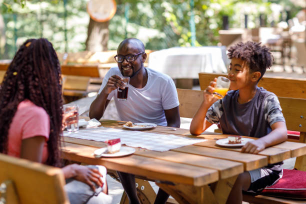 Happy African Family At The Restaurant stock photo