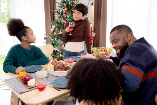 happy-african-family-eating-food-in-dinner-on-festive-thanksgiving-picture-id1357221803?k=20&m=1357221803&s=612x612&w=0&h=1UU4_9I-coEREx-Nz_0eEww1sTzT3001-YOsPHElLH0=