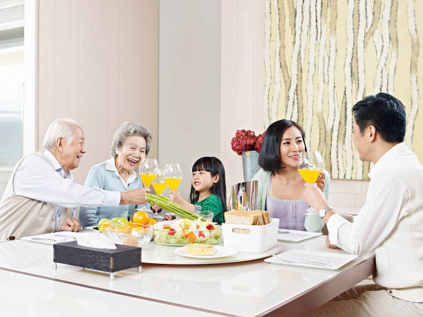happy asian family three-generation family having meal at home. child korea little girls korean ethnicity stock pictures, royalty-free photos & images