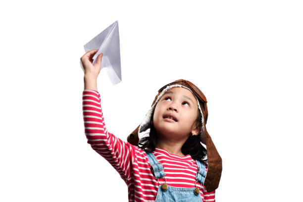 Happy asian little girl playing with toy paper airplane Happy asian little girl playing with toy paper airplane isolated over white background indonesian girl stock pictures, royalty-free photos & images