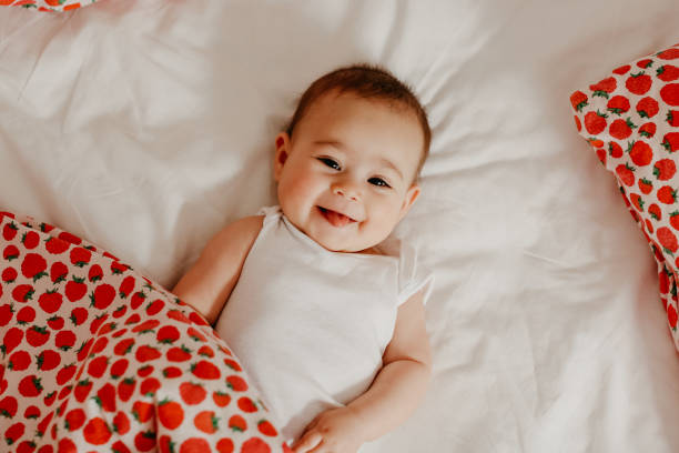 Happy baby baby girl bedding photos stock pictures, royalty-free photos & images