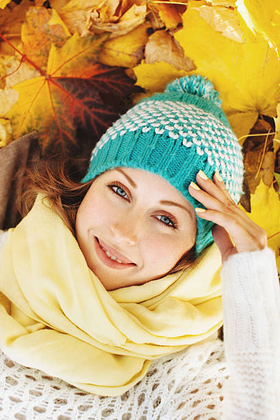 Happy beautiful woman in autumnal park stock photo