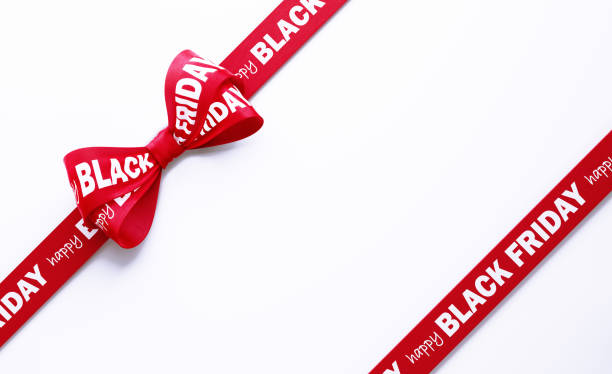Happy Black Friday written red tied bow over white background. Horizontal composition with clipping path and copy space. Black Friday concept.