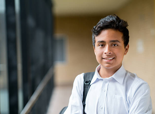 Happy boy at school Portrait of a happy boy at school looking at the camera smiling - education concepts colombian ethnicity stock pictures, royalty-free photos & images