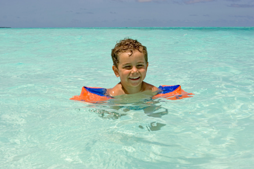 Happy Boy With Floaties Learning To Swim Stock Photo - Download Image Now - iStock