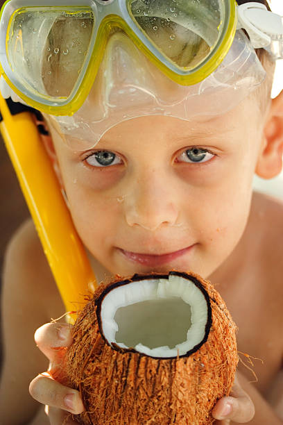 Happy boy with the coconut stock photo