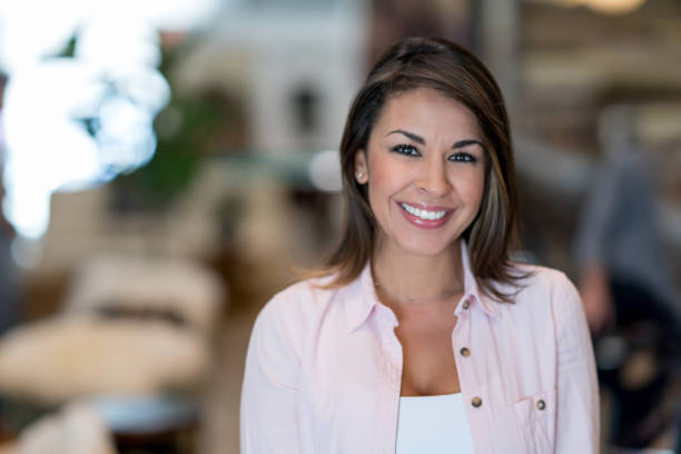Happy business owner at a restaurant Portrait of a happy business owner at a restaurant looking at the camera smiling beautiful latina woman stock pictures, royalty-free photos & images