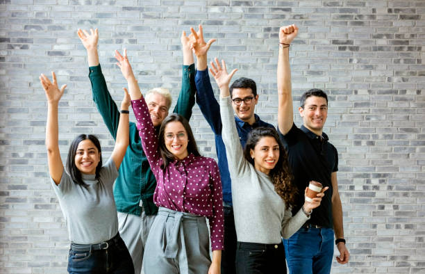 Happy business people celebrating success at office stock photo