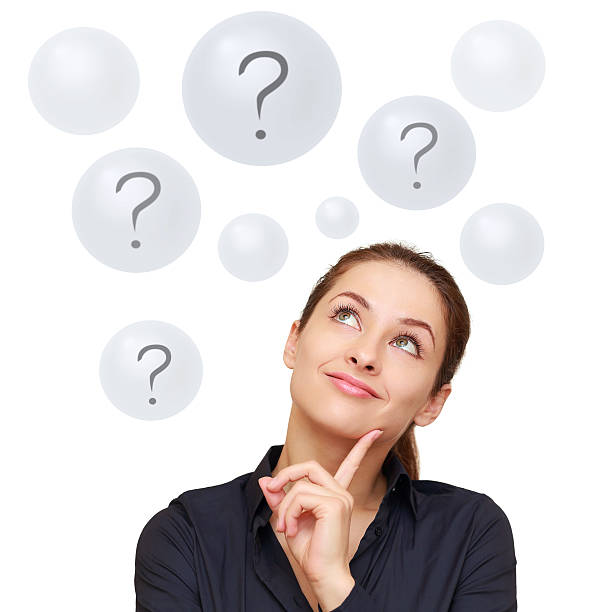 Happy business woman looking on questions in bubbles isolated stock photo