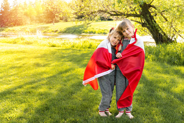 Happy Canda Day Celebration concept. Young girls wearing pijamas with Canadian flag. 1st of July - Independence Day stock photo