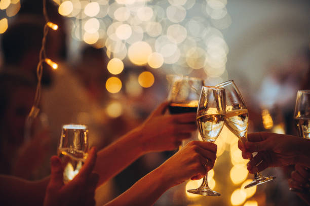 Happy Celebratory Toast with String Lights Champagne and Red Wine stock photo