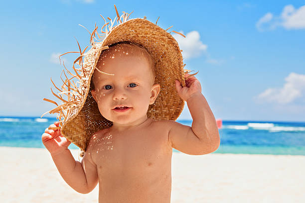 Happy child with straw had on beach on family vacation stock photo