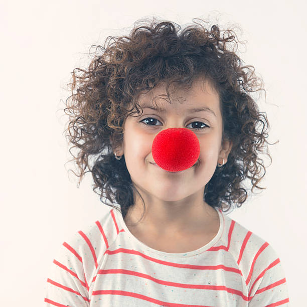 Happy clown Little girl with a big clown nose clown's nose stock pictures, royalty-free photos & images