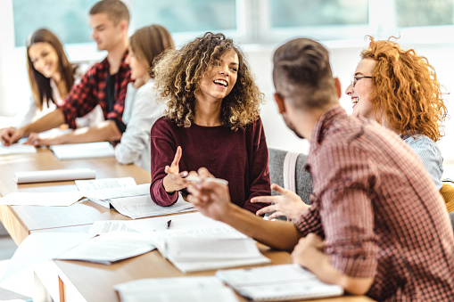 Happy College Students Talking On A Class In The Classroom Stock Photo -  Download Image Now - iStock