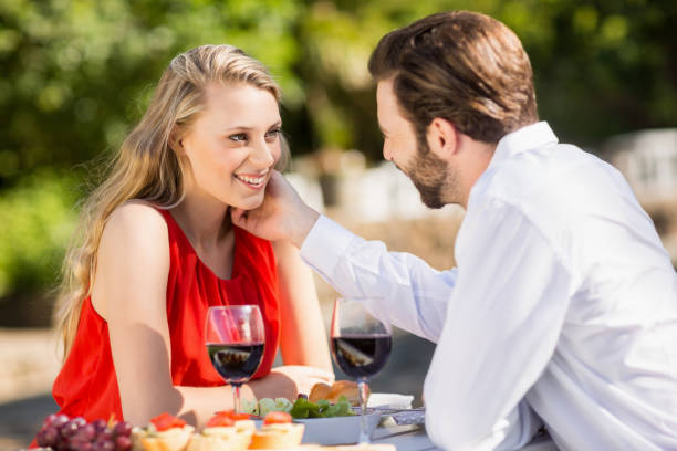 Happy couple embracing each other Happy couple embracing each other in the restaurant cougar woman stock pictures, royalty-free photos & images