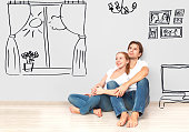 Concept family: Happy couple in the new apartment dream and plan interior