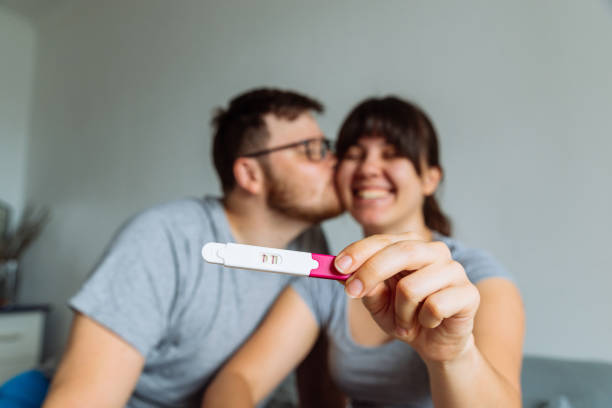 happy couple looking on pregnancy test happy couple looking on pregnancy test positive pregnancy test stock pictures, royalty-free photos & images