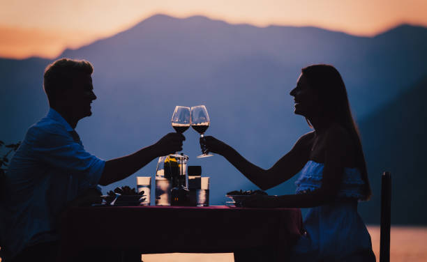 Happy couple on summer evening having romantic dinner outdoor stock photo