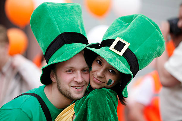 Happy couple portrait St Patrick's day parade in an Irish village.. Adobe RGB
