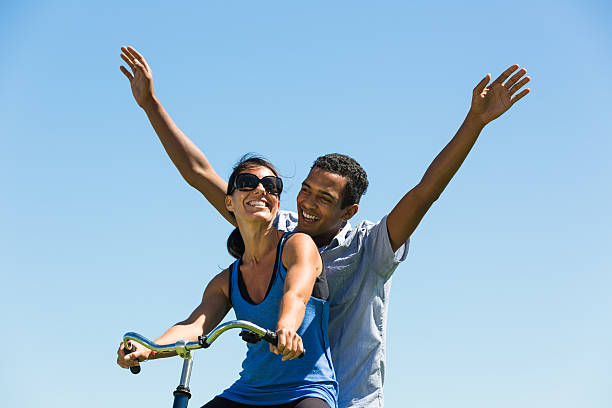 Happy Couple Share a Bicycle stock photo