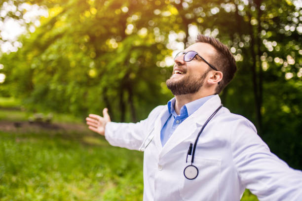 Happy doctor getting away from it all in nature. stock photo