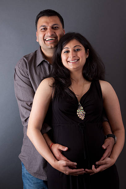 Happy East Indian Husband with his Pregnant wife stock photo