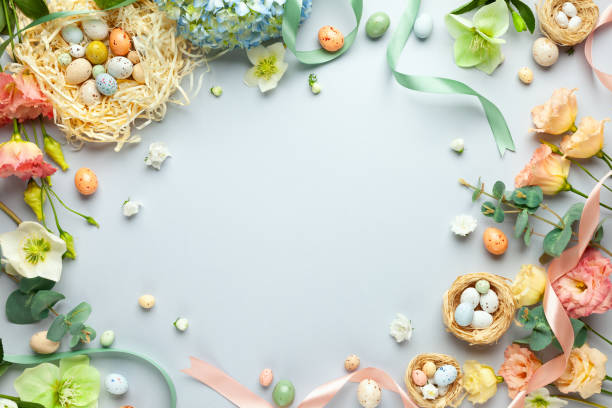 Happy Easter concept with easter eggs in nest and spring flowers. stock photo