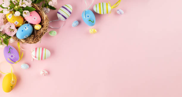 Happy Easter panoramic background with Easter eggs in nest and spring flowers on pink. Happy Easter panoramic background with Easter eggs in nest and spring flowers on pink. Easter, spring concept with copy space. Flat lay, top view. easter sunday stock pictures, royalty-free photos & images